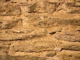 alt Stein Mauer Muster schließen Aussicht Hintergrund, uralt Ziegel Oberfläche foto