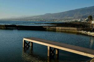 ein Seebrücke im das Wasser mit Berge im das Hintergrund foto