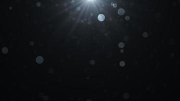 schwarzer fallender leuchtender Partikelhintergrund foto