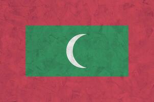 Malediven-Flagge in hellen Farben auf alter Reliefputzwand dargestellt. strukturierte Fahne auf rauem Hintergrund foto