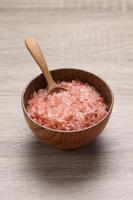 Himalaya rosa Salz in Holzschale auf dem Tisch foto