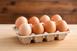 Eier im Karton auf hölzernem Hintergrund foto