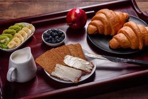 leckeres Frühstück mit frischen Croissants und reifen Beeren foto