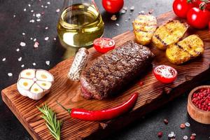 Ribeye Steak mit Kartoffeln, Zwiebeln und Cherrytomaten foto