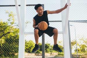 schwarz Mann tun Sport, spielen Basketball auf Sonnenaufgang, aktiv Lebensstil, sonnig Sommer- Morgen foto