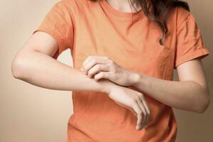 Frauen kratzen juckend Arm mit Hand. foto