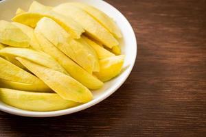 frische grüne und goldene Mango auf Teller geschnitten on