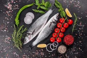 frischer Fisch, Wolfsbarsch und Zutaten zum Kochen. roher Fisch Wolfsbarsch foto