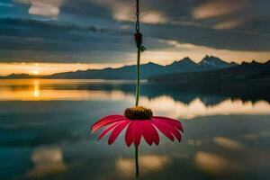 ein Rosa Blume hängt von ein Haken im Vorderseite von ein See. KI-generiert foto