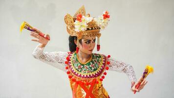 Mädchen tragen balinesisch traditionell Kleid mit ein Tanzen Geste auf Weiß Hintergrund mit Handheld Fan, Krone, Schmuck, und Gold Ornament Zubehör. isoliert balinesisch Tänzer Frau Porträt foto