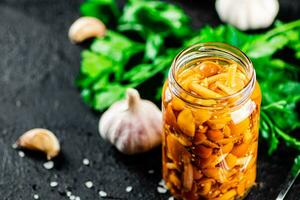 mariniert Pilze mit ein Glas Krug mit Petersilie und Knoblauch. foto