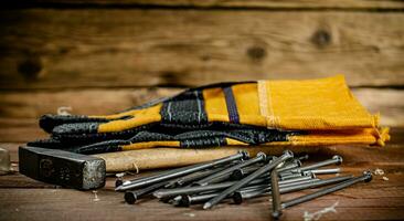 Nägel mit Hammer und Handschuhe. foto