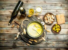 köstlich Fondue Käse mit Oliven und Weiß Wein. foto