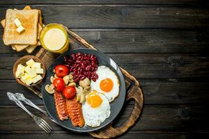 traditionell Englisch Frühstück mit gebraten Eier, Würste und Bohnen. foto