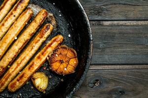 Grill das Würste im das Pfanne. foto