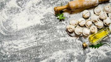 hausgemacht Ravioli mit Olive Öl und mit ein rollen Stift. foto