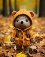 ein gehäkelt Teddy Bär tragen ein Orange Jacke generativ ai foto