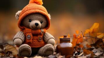 ein Teddy Bär tragen ein Orange Sweatshirt und Hut sitzt im das Blätter generativ ai foto