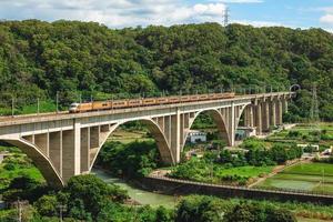 Ein Zug überquert die Liyutan-Bogenbrücke in Miaoli, Taiwan foto
