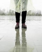 Frau, die im Regen läuft, in Pfützen steht foto