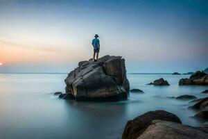 ein Mann Stehen auf ein Felsen im das Ozean beim Sonnenuntergang. KI-generiert foto