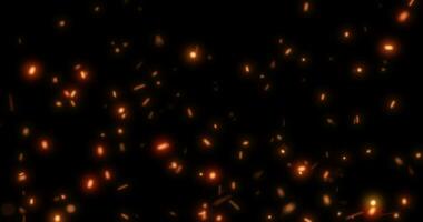 abstrakt hell Hintergrund von fliegend Gelb glühend Orange Feuer Funken von ein Feuer auf ein schwarz Hintergrund foto