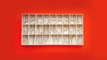 Holz-Alphabetblöcke mit Buchstaben - Box auf rotem Grund foto