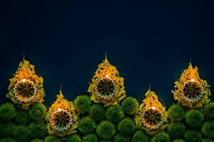 Lehm Diya Lampen einstellen wie Flamme gestalten zündete zu feiern zum Diwali Festival mit bunt Blumen auf dunkel Blau Hintergrund. foto
