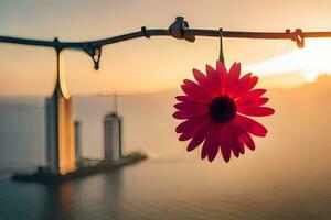 ein rot Blume hängend von ein Draht mit ein Stadt im das Hintergrund. KI-generiert foto