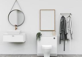 Badezimmer mit Waschbecken mit Bademänteln und wandmontiertem Bilderrahmen foto