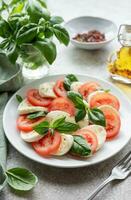 Caprese-Salat mit Tomaten, Mozzarella und Basilikum. foto