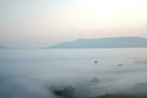 schön Sonnenuntergang und Sonnenaufgang auf Himmel und golden Dämmerung Zeit mit Nebel und Nebel im Senke von Schicht Berg foto