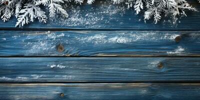 Weihnachten Hintergrund mit Schnee und Tanne Baum Geäst auf Blau hölzern Bretter ai generiert foto