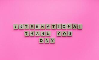 Januar 11, International danken Sie Tag, minimalistisch Banner mit das Inschrift im hölzern Briefe foto