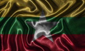 Tapete von Myanmar-Flagge und wehende Flagge von Stoff. foto
