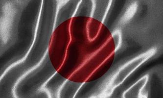 Tapete von Japan-Flagge und wehende Flagge von Stoff. foto