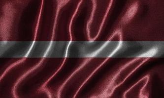 Tapete von Lettland-Flagge und wehende Flagge von Stoff. foto
