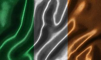 Tapete von Irland-Flagge und wehende Flagge von Stoff. foto