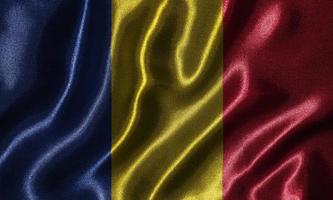 Tapete von Rumänien-Flagge und wehende Flagge von Stoff. foto