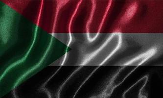 Tapete von Sudan-Flagge und wehende Flagge von Stoff. foto