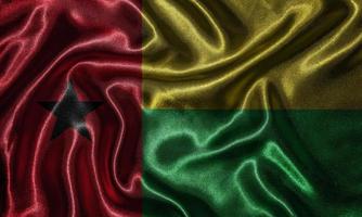 Tapete von Guinea-Bissau-Flagge und wehende Flagge von Stoff. foto