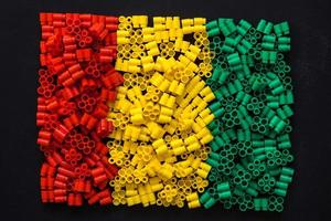 Plastikbausteine in Rot, Gelb und Grün auf schwarzem Hintergrund foto
