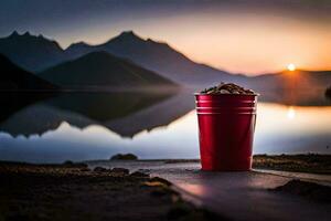 ein rot Tasse auf das Ufer von ein See mit Berge im das Hintergrund. KI-generiert foto