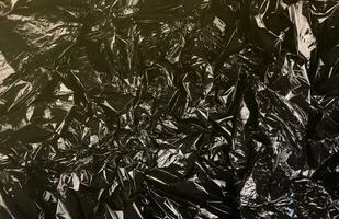 Textur von schwarz Plastik Müll Einweg Tasche foto