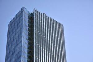 Glas Gebäude mit transparent Fassade von das Gebäude und Blau Himmel. strukturell Glas Mauer reflektieren Blau Himmel. abstrakt modern die Architektur Fragment. zeitgenössisch architektonisch Hintergrund. foto