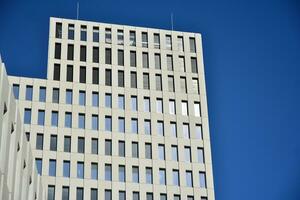 modern Büro Gebäude Detail. Perspektive Aussicht von geometrisch eckig Beton Fenster auf das Fassade von ein Modernist Brutalist Stil Gebäude. foto