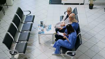 Allgemeines Praktiker Arzt und Krankenschwester Portion alt Mann zu nehmen aus zervikal Hals Halsband während Untersuchung Besuch geplanter Termin im Krankenhaus warten Zimmer. Alten geduldig Empfang Medizin Unterstützung foto