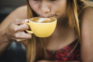 glückliche junge Frau mit Latte-Kaffee am Morgen foto