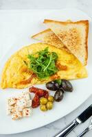 Frühstück von Eier mit Fleisch, Kräuter und Tropfen von Soße mit Brot im ein runden Teller oben Aussicht foto