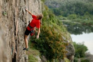 ein Mädchen klettert ein Felsen. Frau beschäftigt, verlobt im extrem Sport. foto